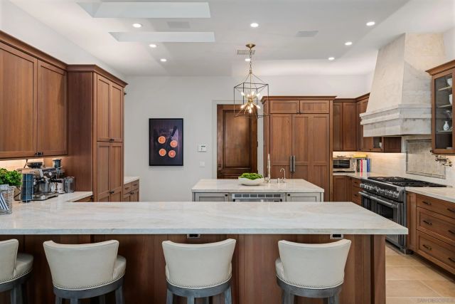 a living room with furniture chandelier and a large window