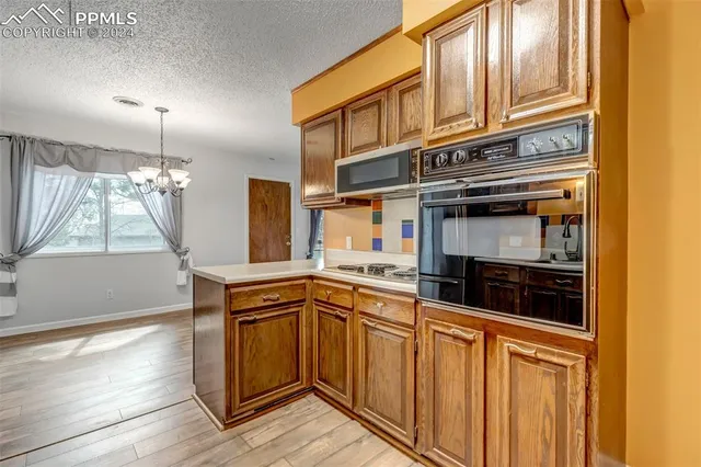 a kitchen with stainless steel appliances granite countertop a stove and a sink