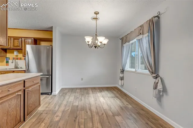 a view of a room with wooden floor and staircase