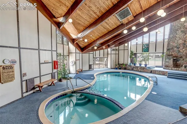 a indoor swimming pool with view of outdoor seating