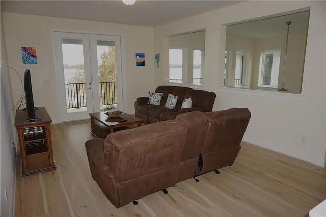 a living room with furniture window and a flat screen tv