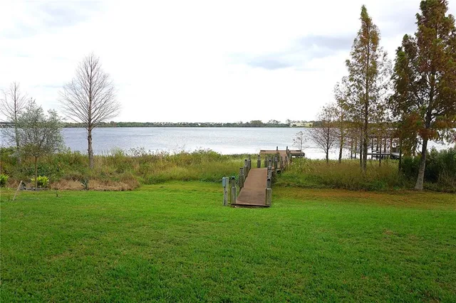a park with water view and large trees