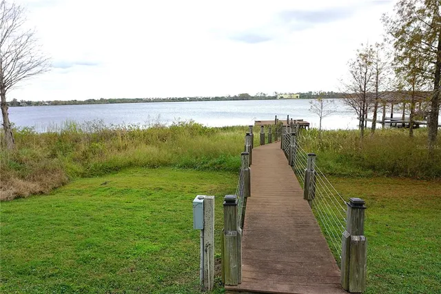 a terrace with outdoor seating and lake view