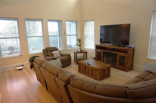 a living room with furniture and a flat screen tv