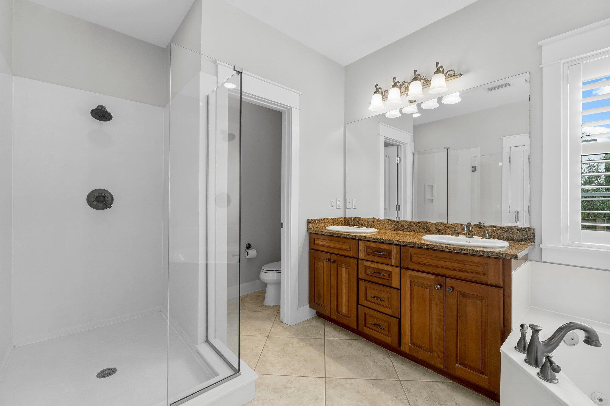 60 Willow Mist Road Inlet Beach, FL 32461 - Photo 22 of 57 a spacious bathroom with a granite countertop sink a mirror and shower