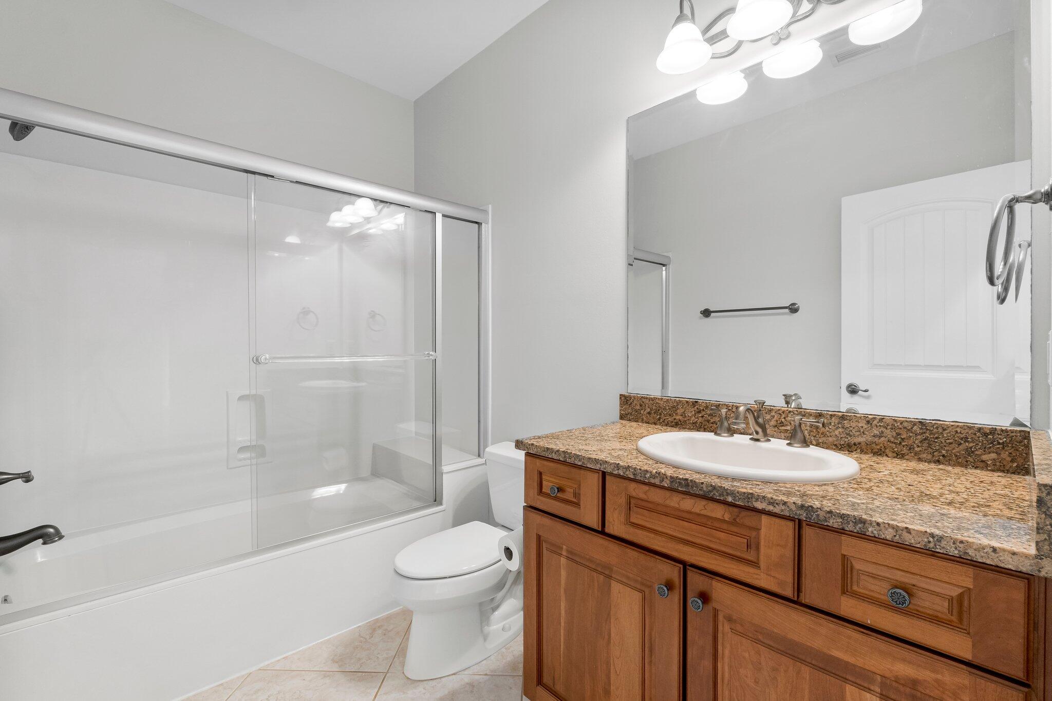 60 Willow Mist Road Inlet Beach, FL 32461 - Photo 31 of 57 a bathroom with a granite countertop sink a toilet a mirror and shower
