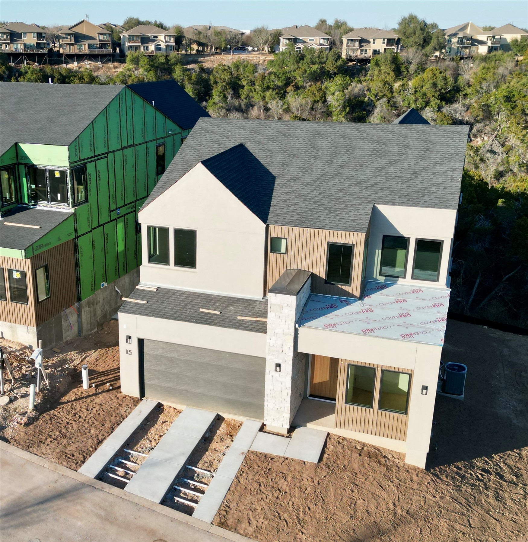 View of front of home with roof with shingles, a residential view, and an attached garage
