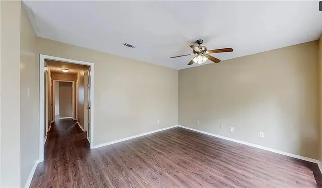 wooden floor in an empty room with a window