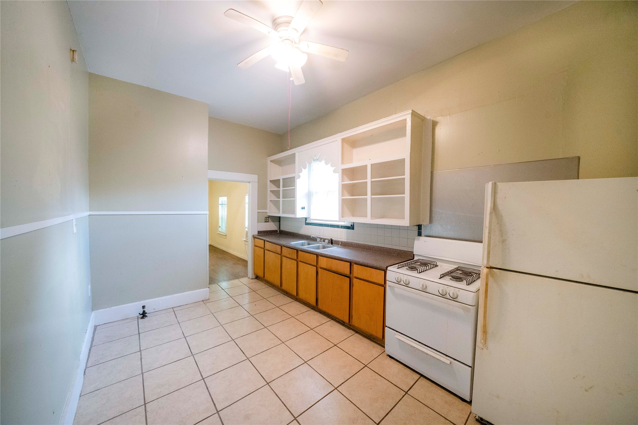 2303 Chestnut Street, Unit A Houston, TX 77009 - Photo 2 of 12 a kitchen with a refrigerator a stove cabinets and living room view