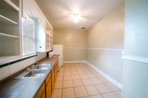 a kitchen with a sink a counter top space and cabinets