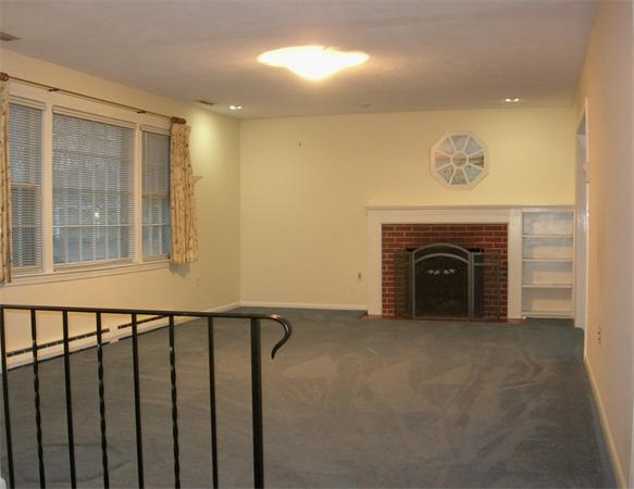 118 Worthen Road Lexington, MA 02421 - Photo 6 of 15 a view of an empty room with a fireplace