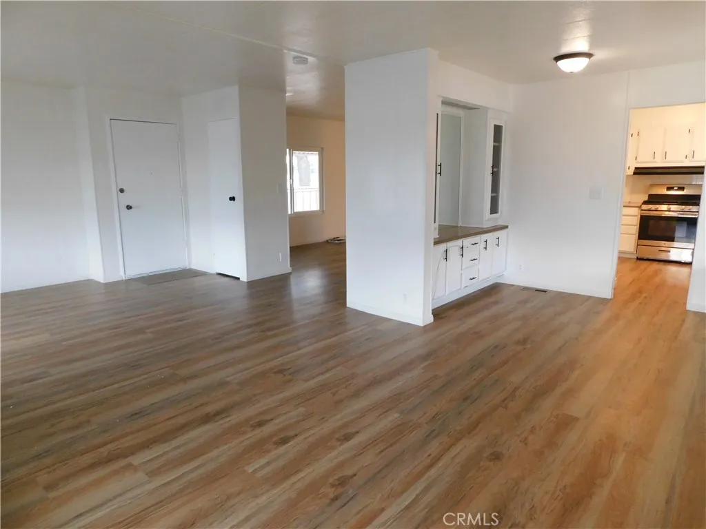 5700 West Wilson Street, Unit 1 Banning, CA 92220 - Photo 4 of 49 a view of kitchen and empty room with wooden floor
