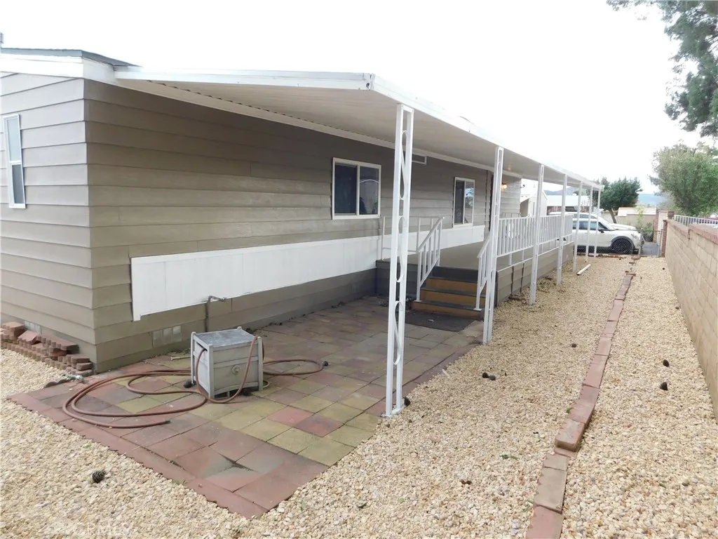 5700 West Wilson Street, Unit 1 Banning, CA 92220 - Photo 45 of 49 a view of a chairs and table in the backyard