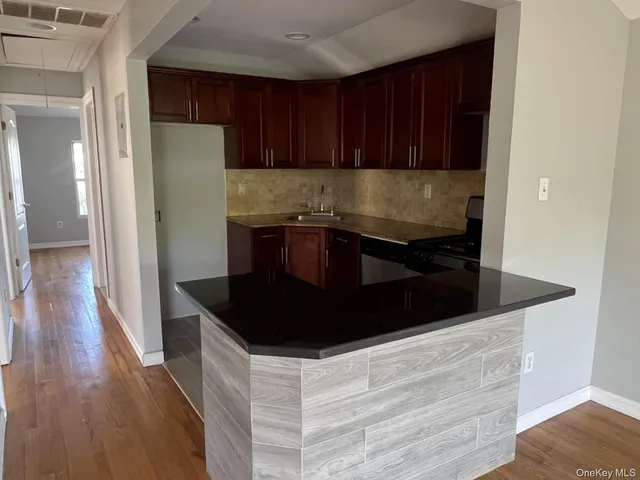 a kitchen with granite countertop a refrigerator and a stove