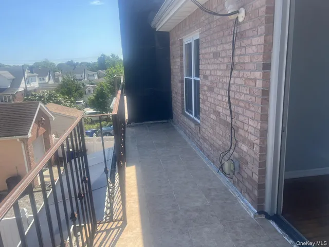 a view of balcony with wooden floor and fence