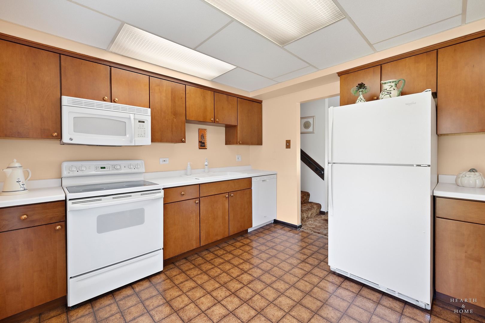 404 Lucille Avenue Fox River Grove, IL 60021 - Photo 6 of 36 a kitchen with a refrigerator sink stove and cabinets
