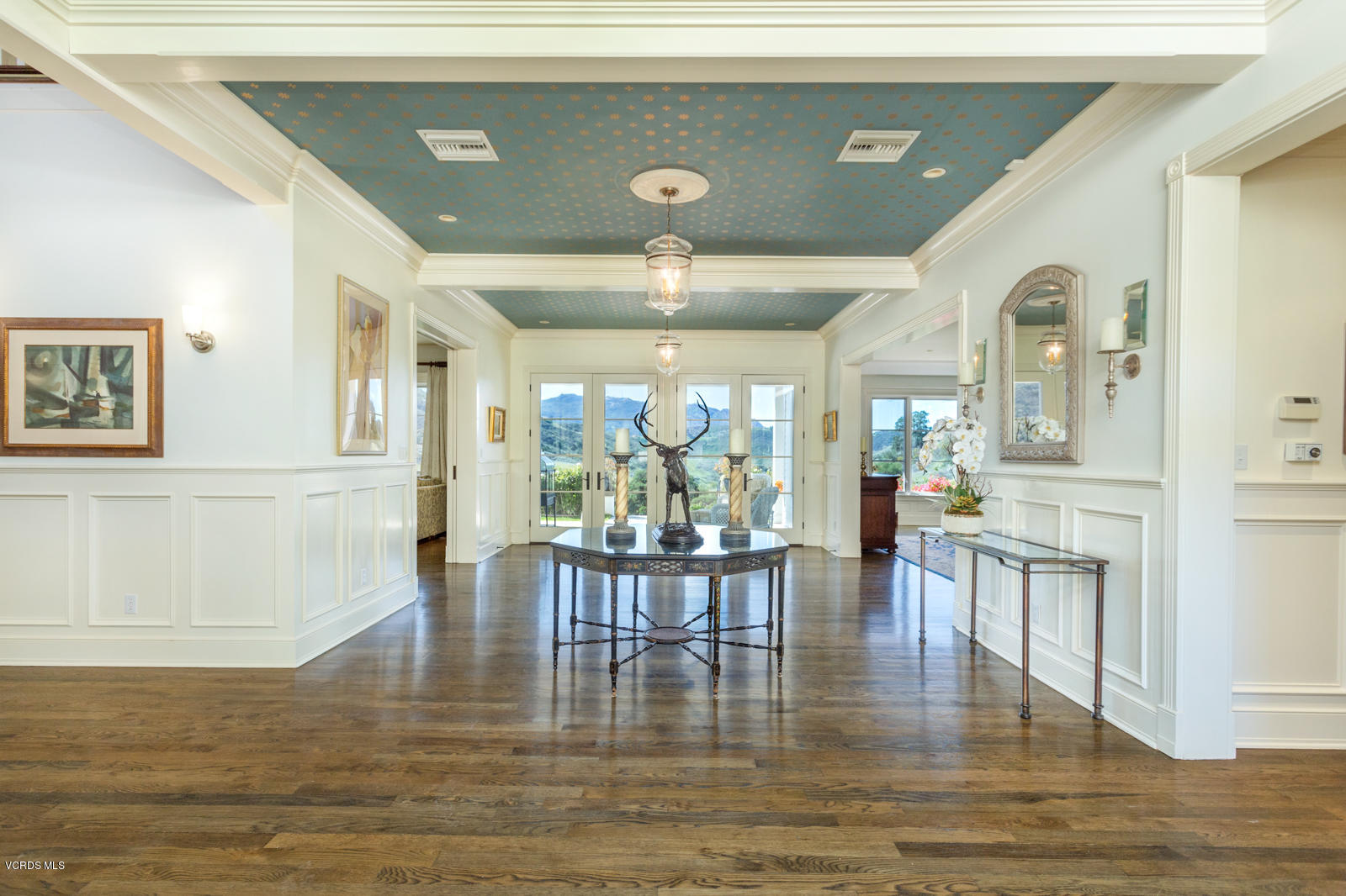 24900 Paseo Del Rancho Road Calabasas, CA 91302 - Photo 12 of 46 a dining room with wooden floor a glass table and chairs