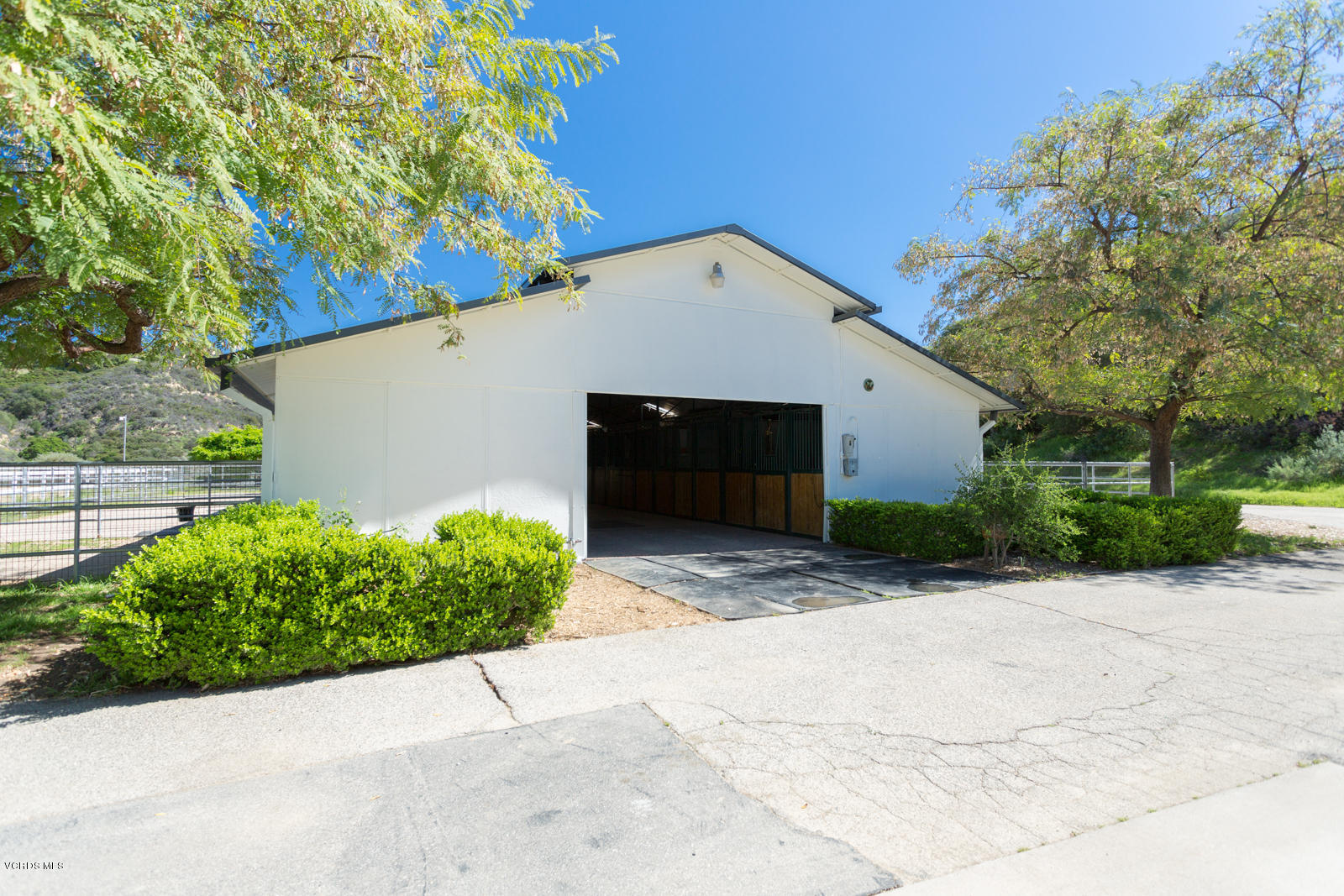 24900 Paseo Del Rancho Road Calabasas, CA 91302 - Photo 40 of 46 a front view of a house with a yard and garage