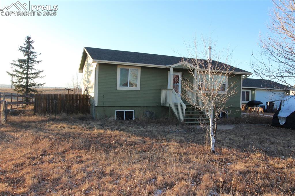 16855 Sage Crest Road Peyton, CO 80831 - Photo 1 of 27 a house view with a backyard space