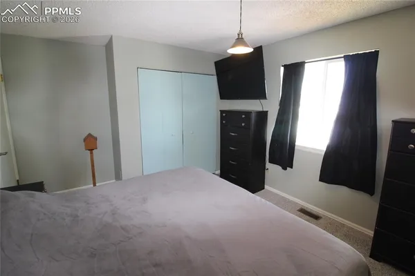 a bed room with a bed and a television