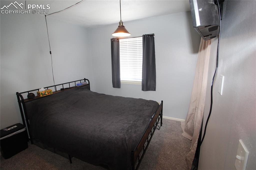 16855 Sage Crest Road Peyton, CO 80831 - Photo 13 of 27 a bedroom with a bed and a window