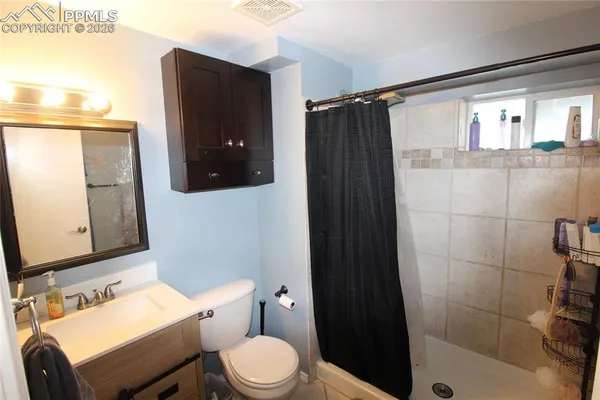 a bathroom with a sink toilet and shower