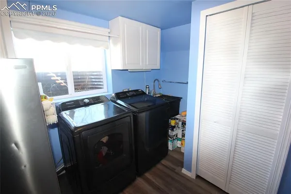 a utility room with sink dryer and washer