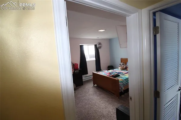 a bedroom with a bed and a television