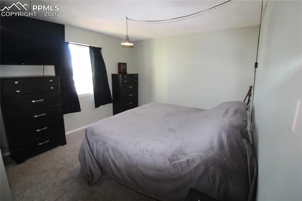 a bed room with a bed and a television