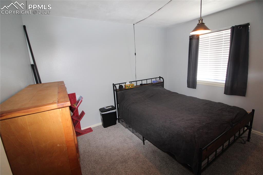 16855 Sage Crest Road Peyton, CO 80831 - Photo 6 of 27 a bedroom with a bed and a window