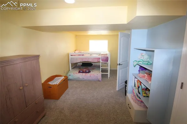 a living room with furniture and a baby crib