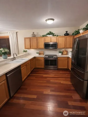 a kitchen with stainless steel appliances granite countertop a sink and stove top oven