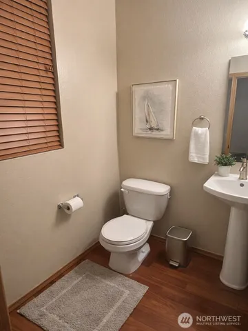 a white toilet sitting next to a bathroom sink