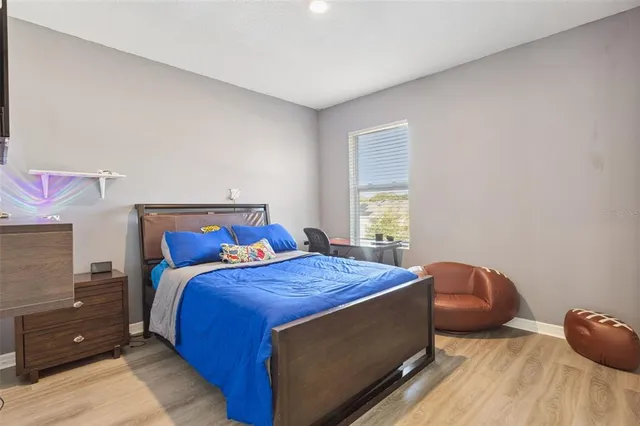 a bed sitting in a bedroom next to a window