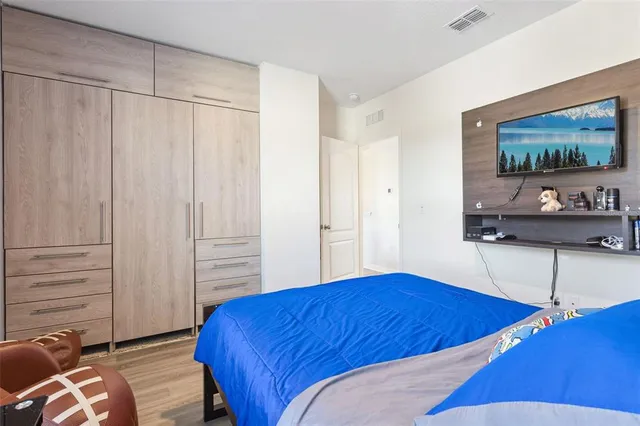 a bedroom with a bed and a flat screen tv