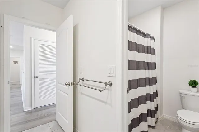 a bathroom with a shower toilet and sink