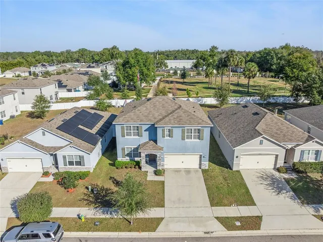 an aerial view of residential houses with outdoor space