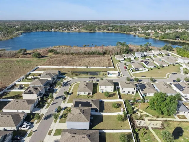 an aerial view of a house with a ocean view