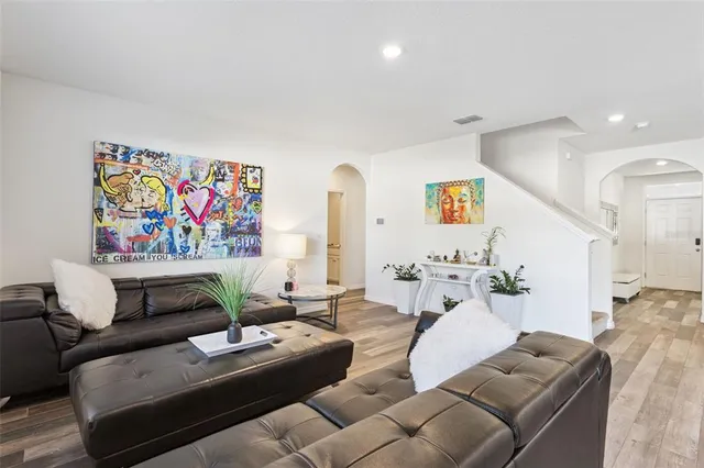 a living room with furniture and wall paintings