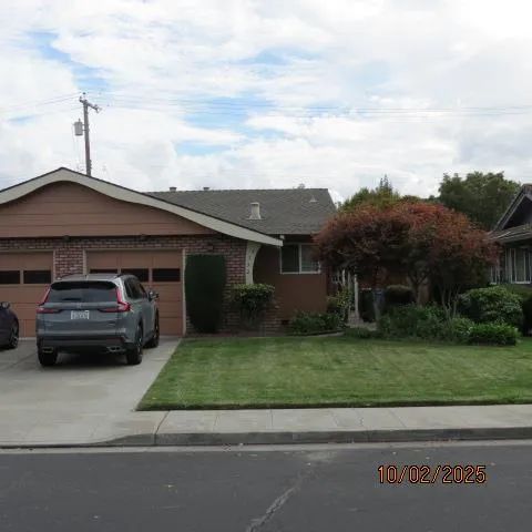 a kitchen with a sink a window and cabinets