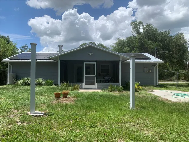 a front view of a house with a yard and porch