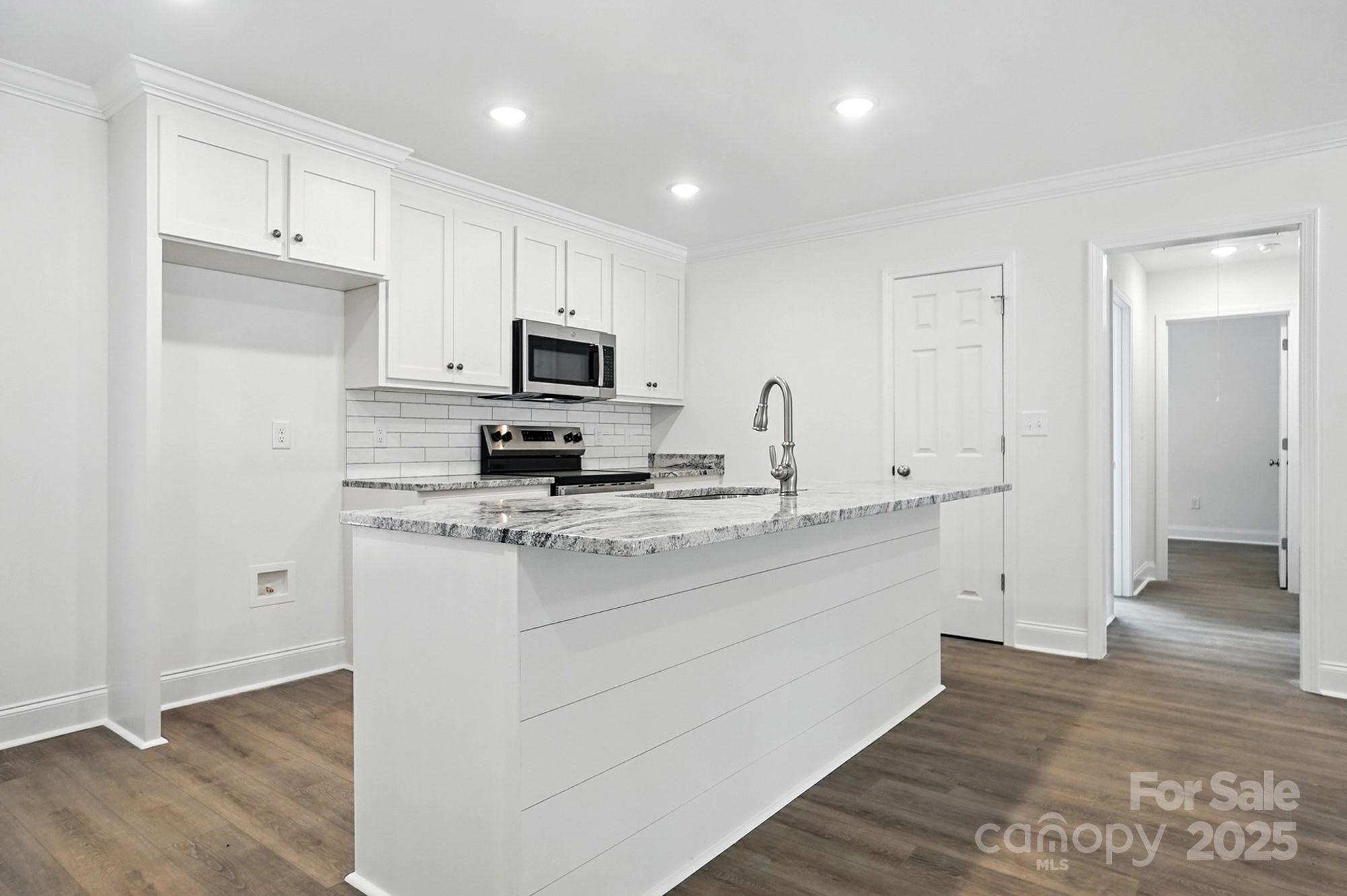 233 Lincoln Road York, SC 29745 - Photo 11 of 37 a kitchen with kitchen island a sink stainless steel appliances and cabinets