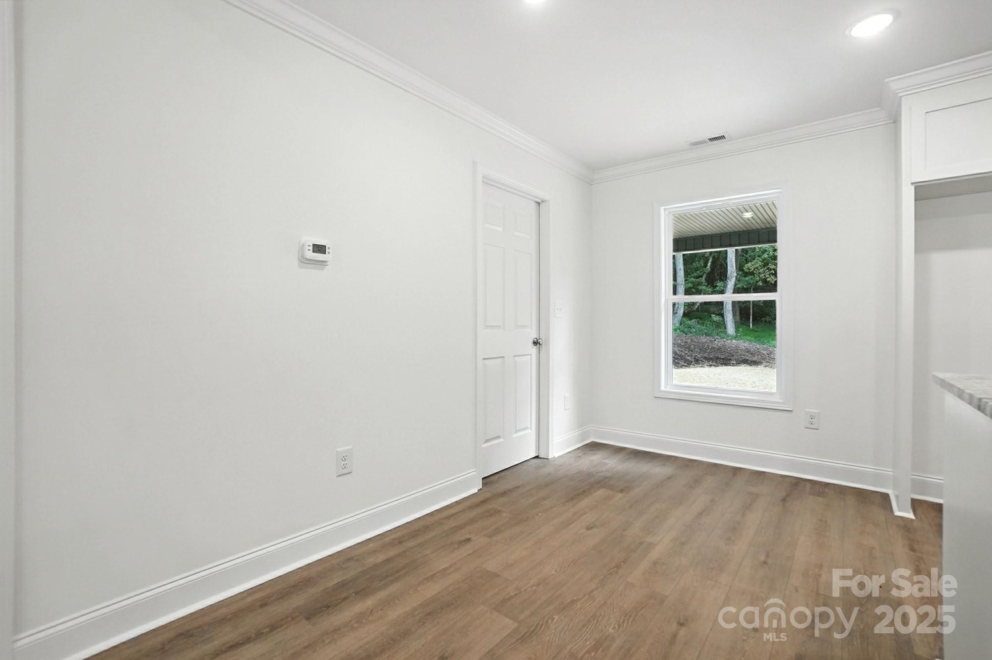 233 Lincoln Road York, SC 29745 - Photo 16 of 37 an empty room with wooden floor and windows