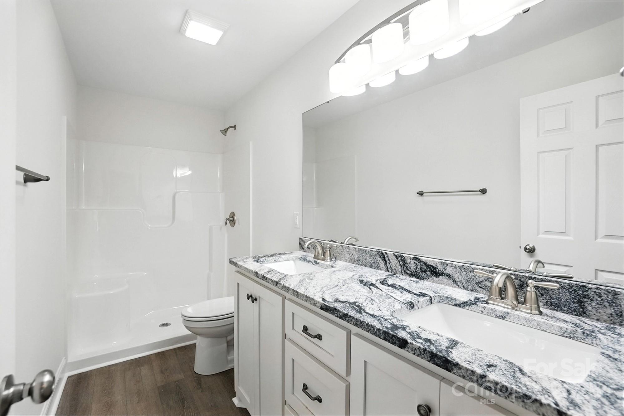 233 Lincoln Road York, SC 29745 - Photo 20 of 37 a bathroom with a granite countertop sink a toilet and a mirror