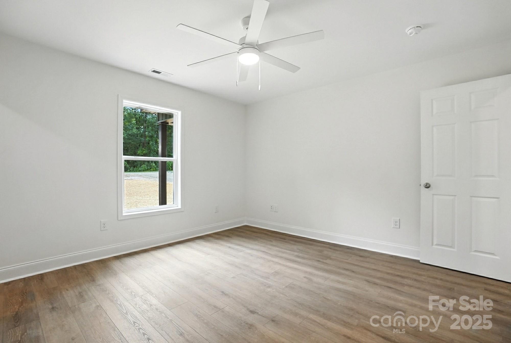 233 Lincoln Road York, SC 29745 - Photo 23 of 37 an empty room with wooden floor and windows