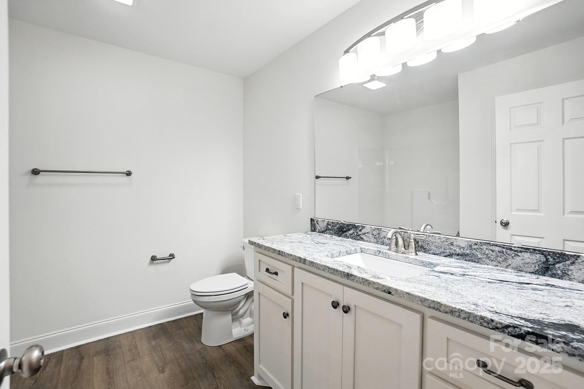 233 Lincoln Road York, SC 29745 - Photo 26 of 37 a bathroom with a granite countertop sink a toilet and a mirror