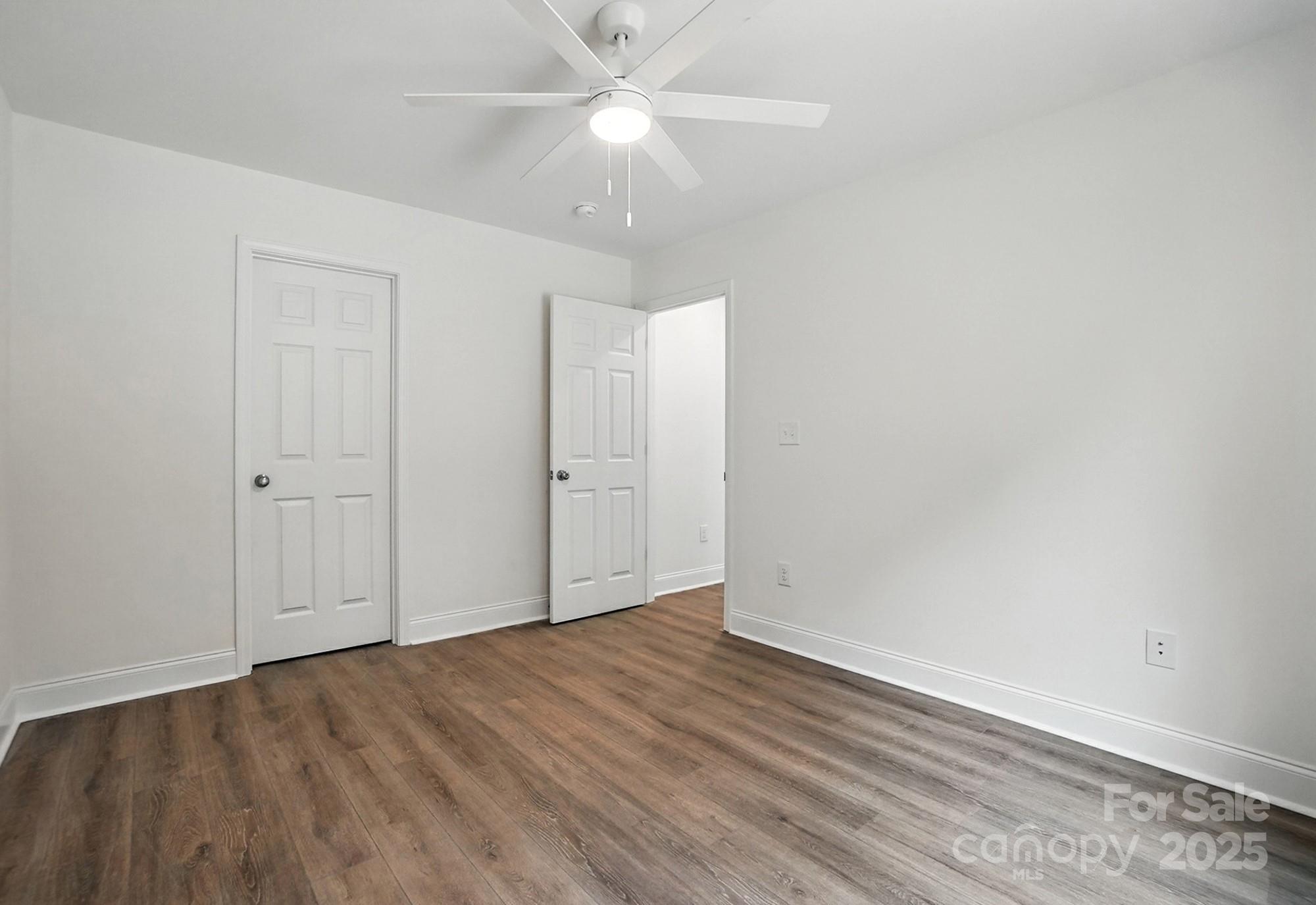 233 Lincoln Road York, SC 29745 - Photo 30 of 37 an empty room with wooden floor and fan