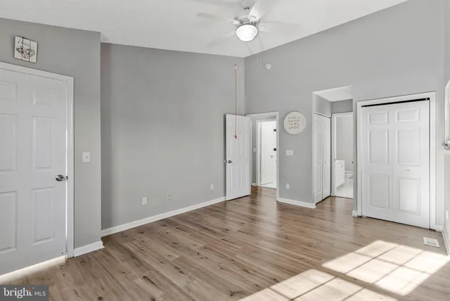 a view of an empty room with wooden floor