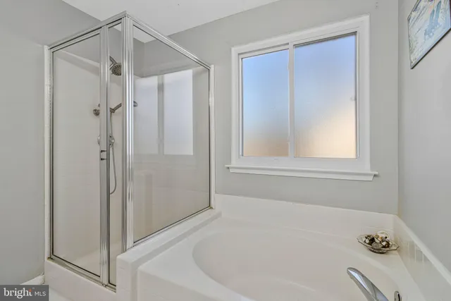 a bathroom with a bathtub and a shower