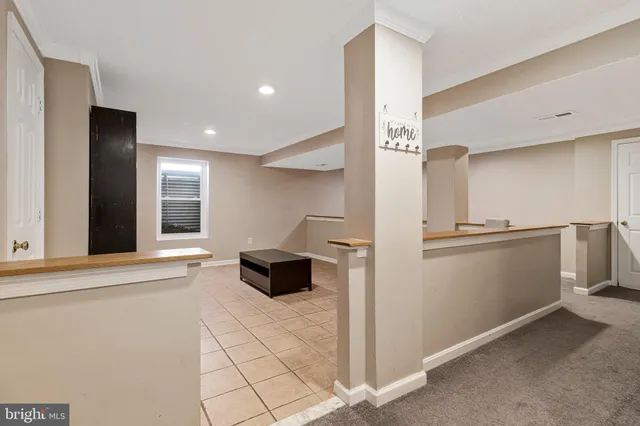 a view of kitchen with cabinets and refrigerator